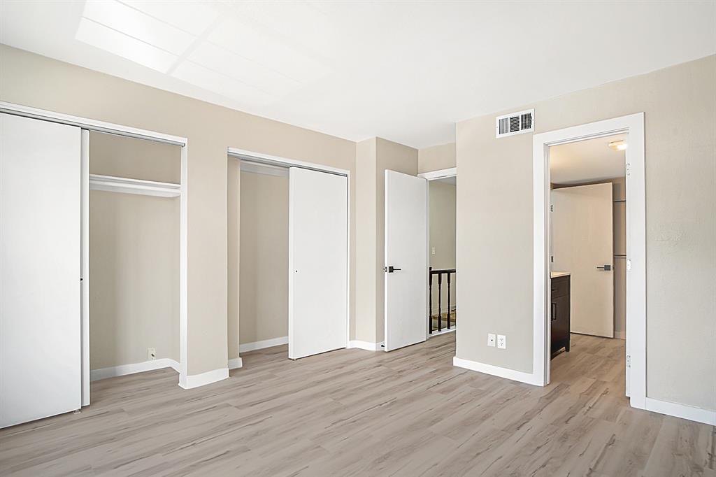 618 West Collins Street Denton, TX 76201 - Photo 17 of 25 Unfurnished bedroom with two closets and light wood finished floors