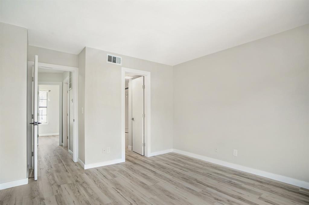 618 West Collins Street Denton, TX 76201 - Photo 18 of 25 Unfurnished bedroom featuring light wood-style flooring and baseboards