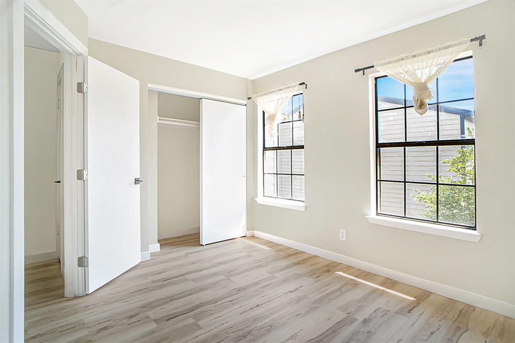 618 West Collins Street Denton, TX 76201 - Photo 20 of 25 Unfurnished bedroom featuring light wood-style flooring and a closet