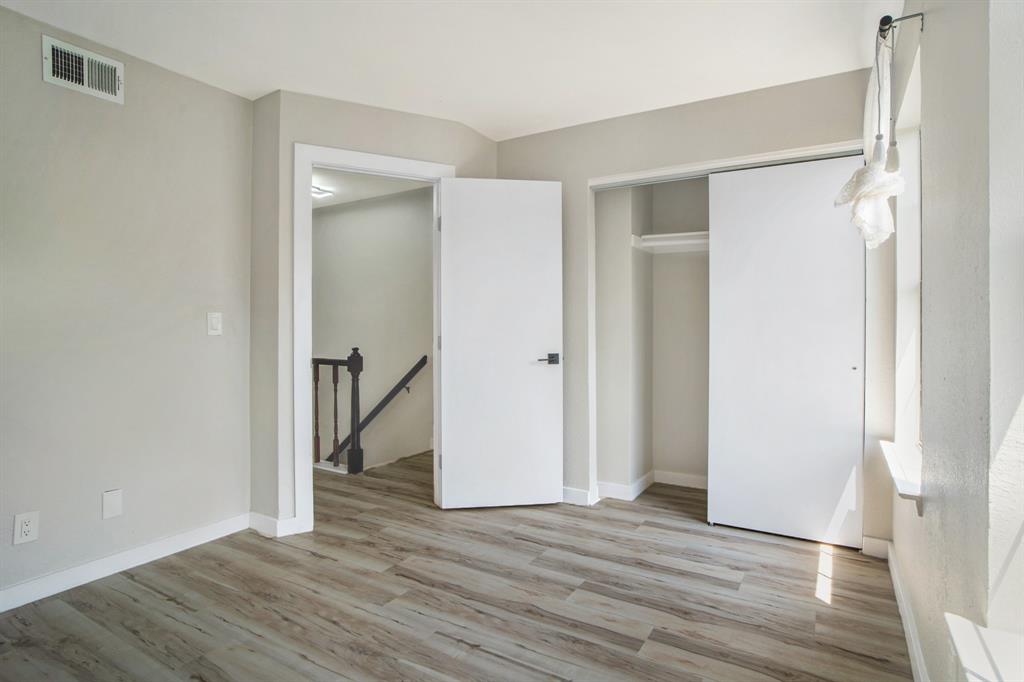 618 West Collins Street Denton, TX 76201 - Photo 21 of 25 Unfurnished bedroom featuring light wood-type flooring and a closet