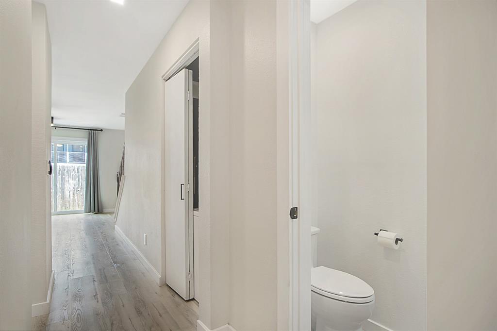618 West Collins Street Denton, TX 76201 - Photo 7 of 25 Hallway featuring baseboards and light wood-style flooring