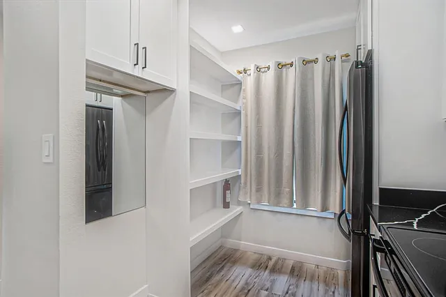 a view of walk in closet with empty racks