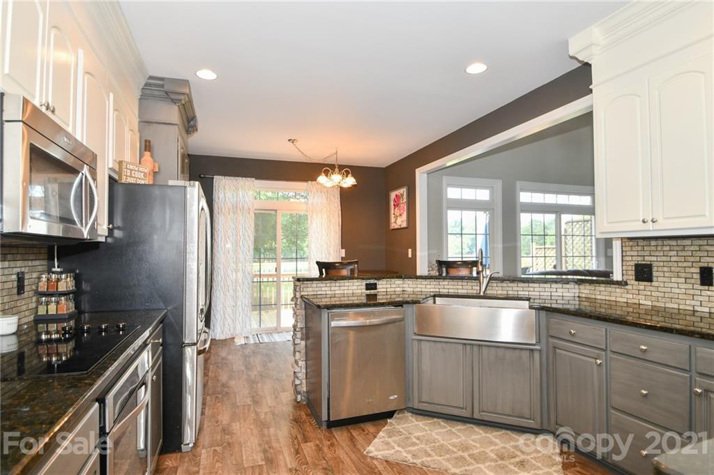3600 Haigler Road Monroe, NC 28110 - Photo 14 of 30 a kitchen with stainless steel appliances granite countertop a stove a sink and a refrigerator