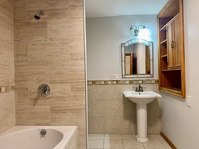 a view of a hallway with a wooden door