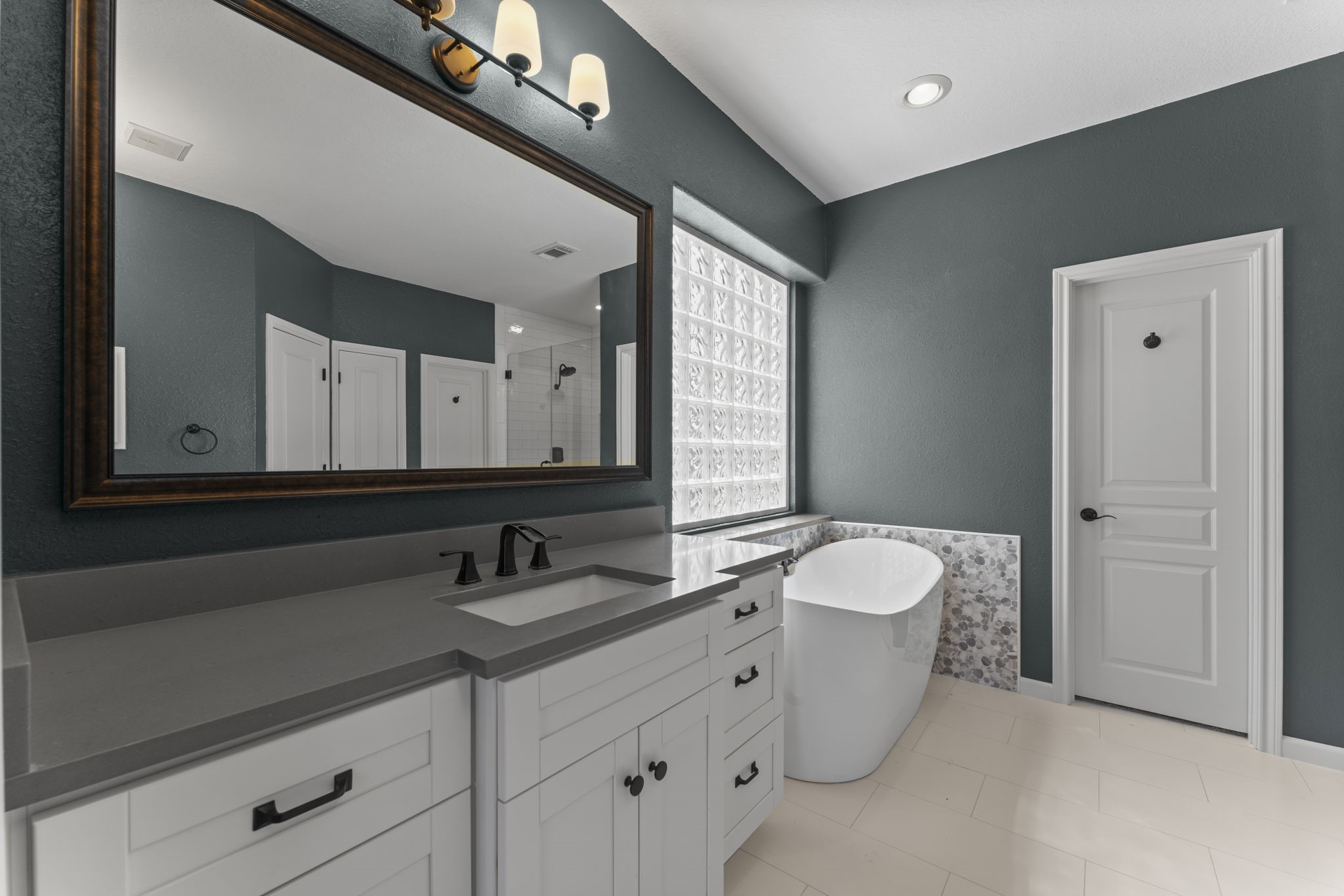 19218 Country Village Drive Spring, TX 77388 - Photo 20 of 35 a bathroom with a double vanity sink and a mirror