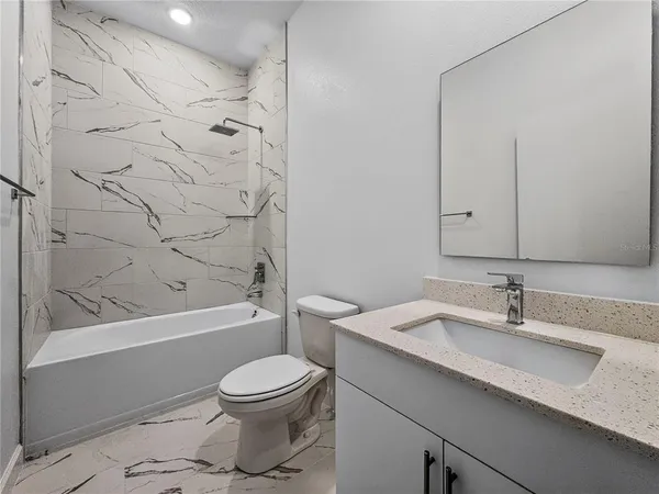 a bathroom with a sink a toilet and a bathtub