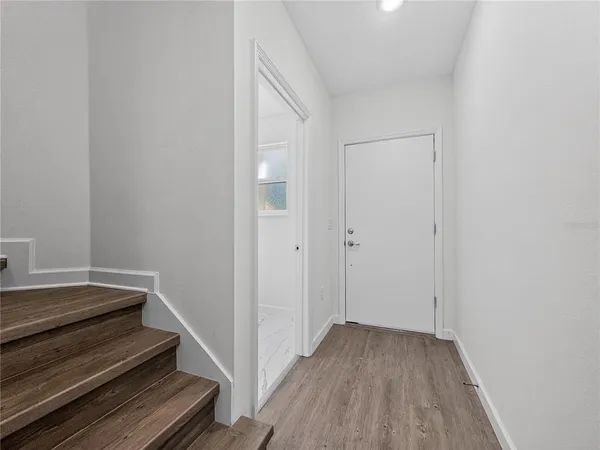 a view of room with wooden floor