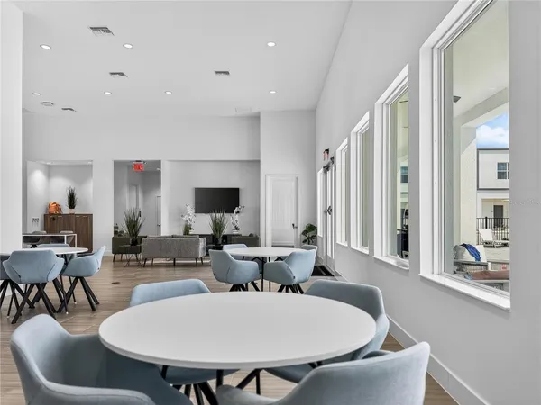 a view of a dining room with a table and chairs