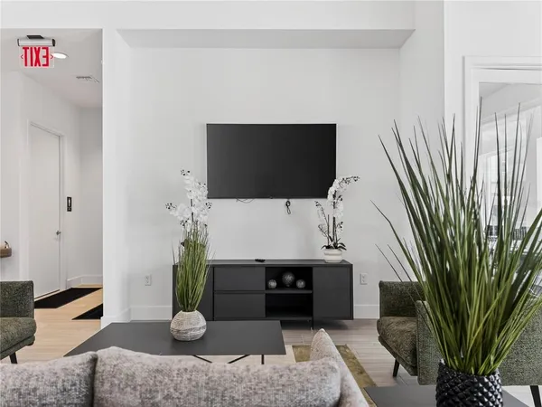 a living room with patio furniture and a floor to ceiling window