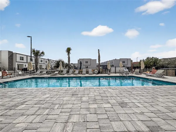 a view of a patio with lawn chairs