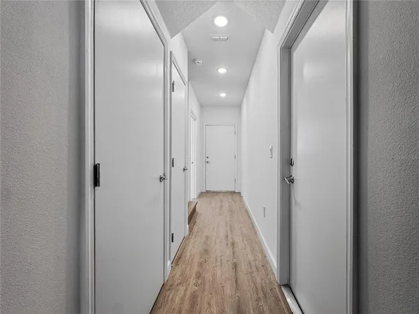 a view of a hallway with wooden floor