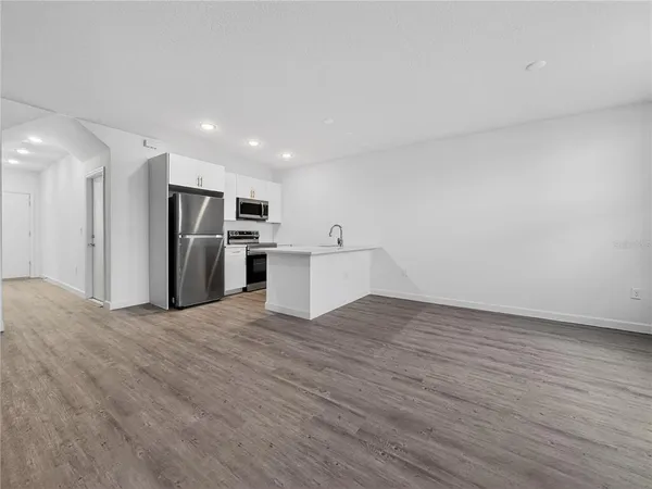 a view of a kitchen with a sink and a refrigerator