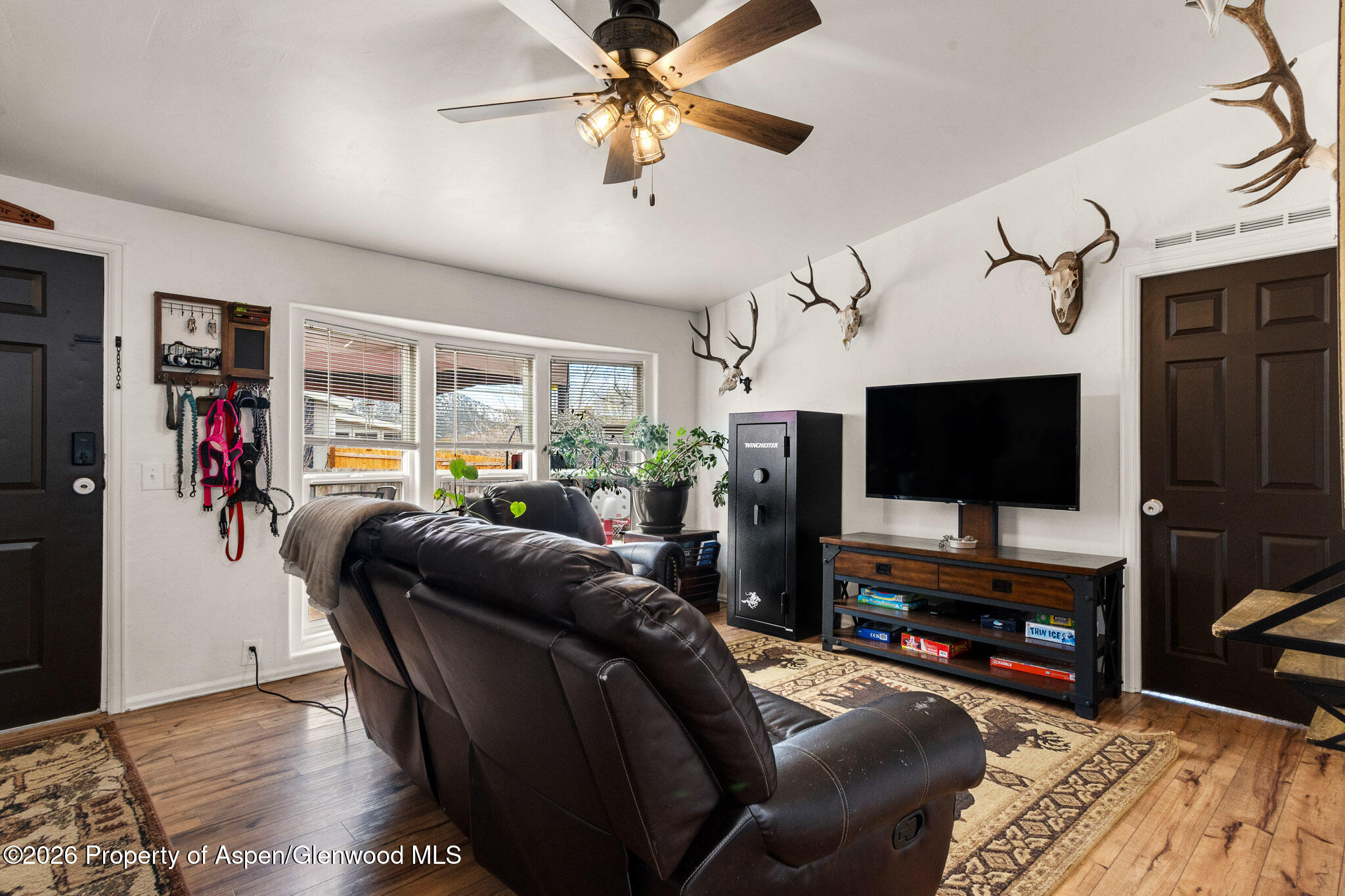 106 Cedar Circle Parachute, CO 81635 - Photo 6 of 35 a living room with furniture and a flat screen tv