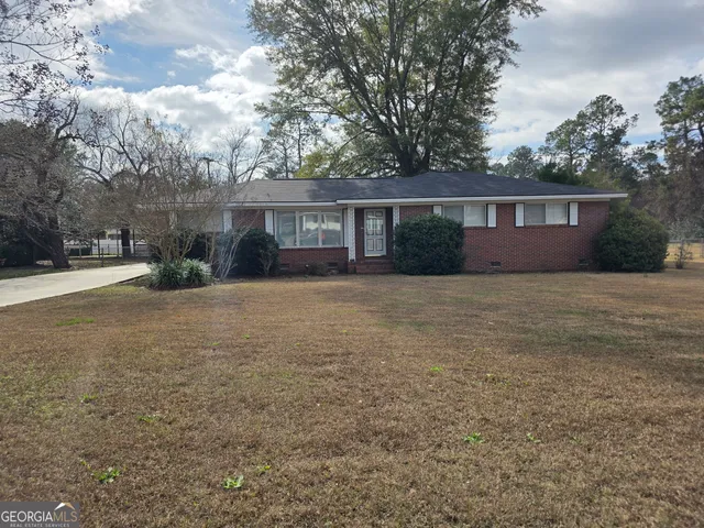 a front view of house with yard and trees