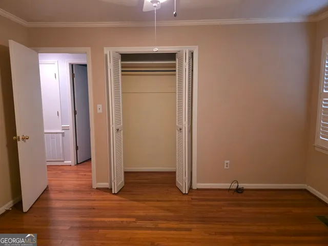 a view of a livingroom with wooden floor and closet