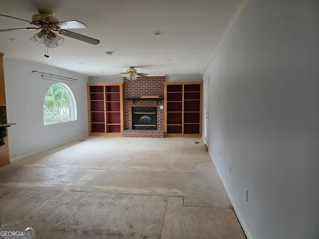 an empty room with furniture and windows