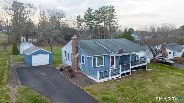 an aerial view of a house with a big yard and large trees