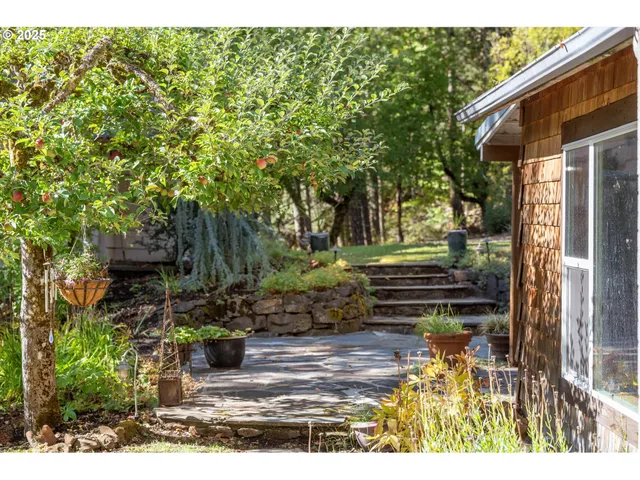 a living room with furniture a rug and kitchen view