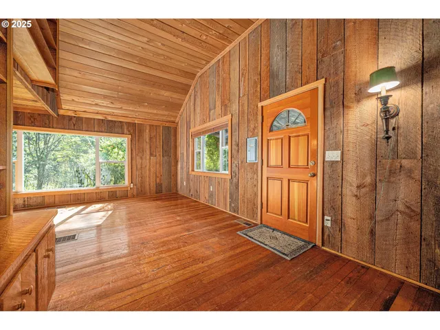 a view of an entryway with wooden floor