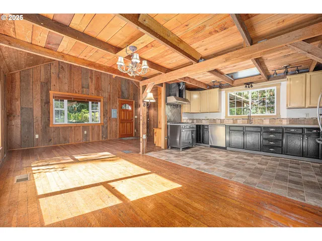 a view of a room with wooden floor and windows