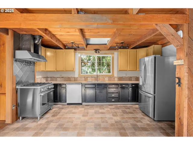 a kitchen with stainless steel appliances granite countertop a refrigerator and a stove top oven