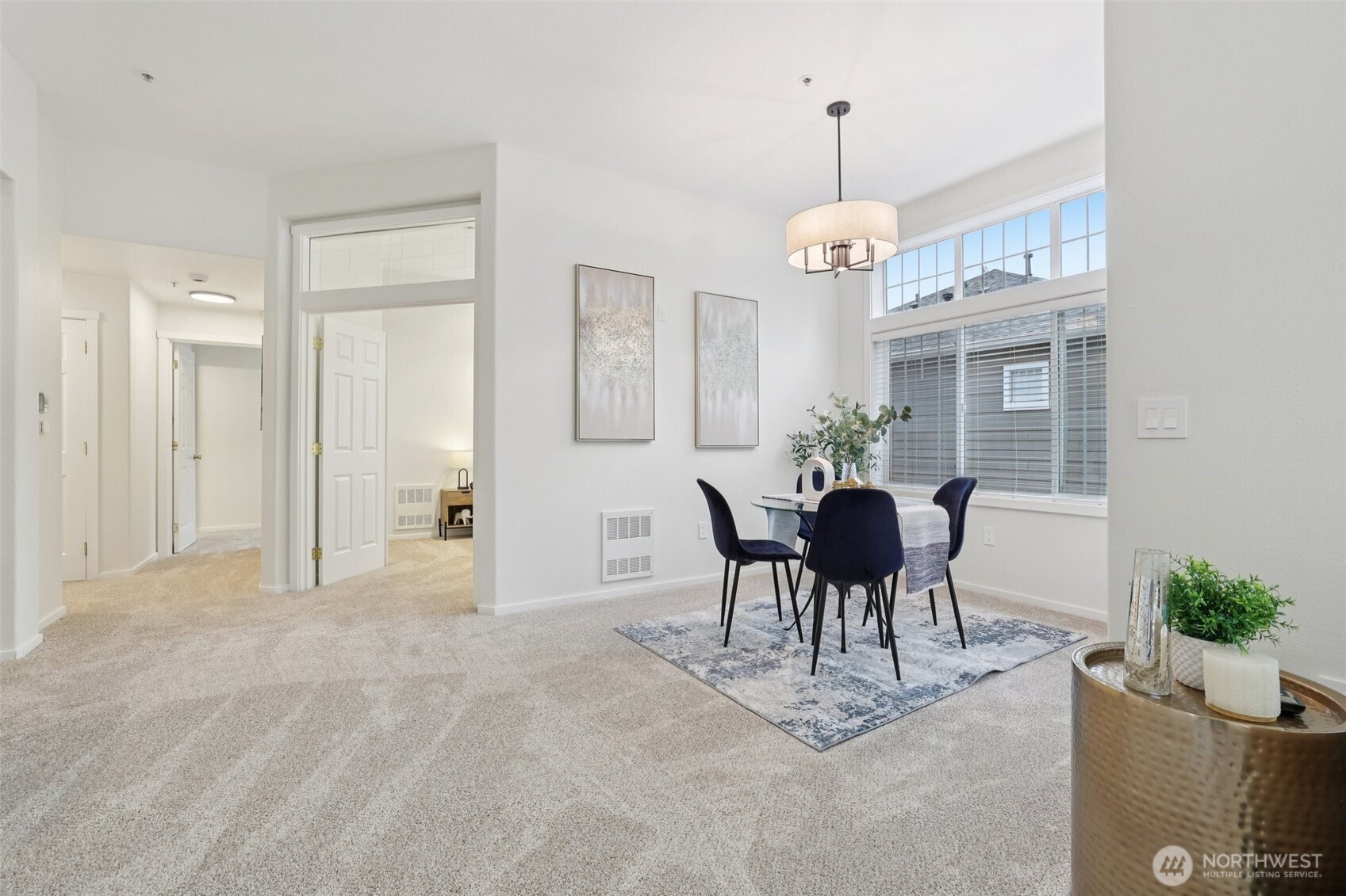 4322 Northeast 5th Court, Unit 105 Renton, WA 98059 - Photo 11 of 36 a dining room with wooden floor a chandelier a glass table and chairs