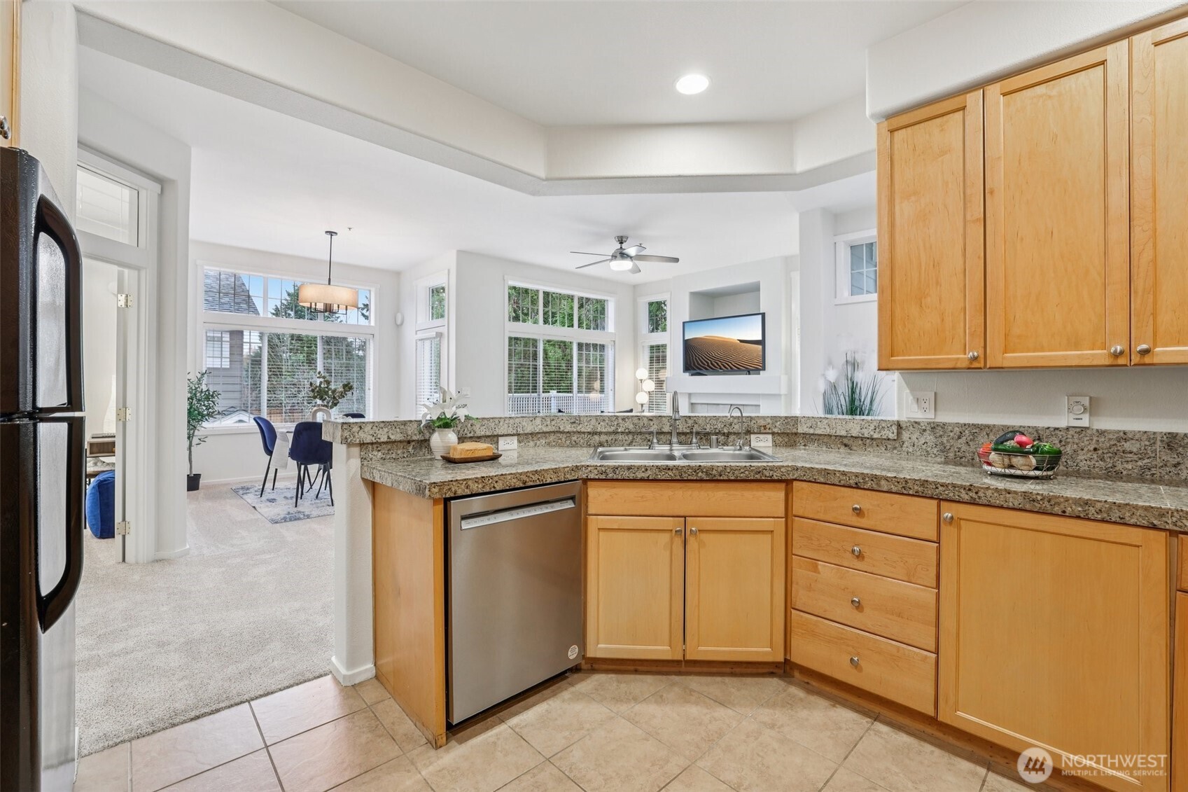 4322 Northeast 5th Court, Unit 105 Renton, WA 98059 - Photo 14 of 36 a kitchen with stainless steel appliances granite countertop a stove a sink and a refrigerator