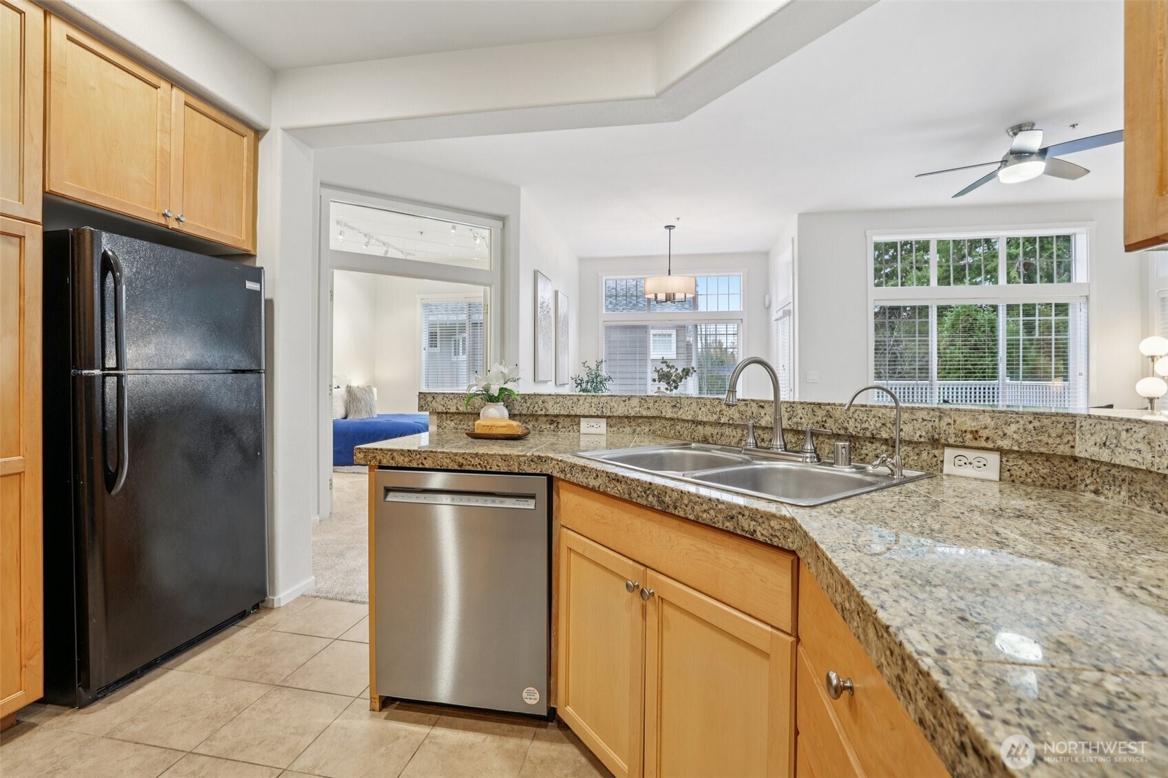 4322 Northeast 5th Court, Unit 105 Renton, WA 98059 - Photo 15 of 36 a kitchen with stainless steel appliances granite countertop a sink stove and refrigerator