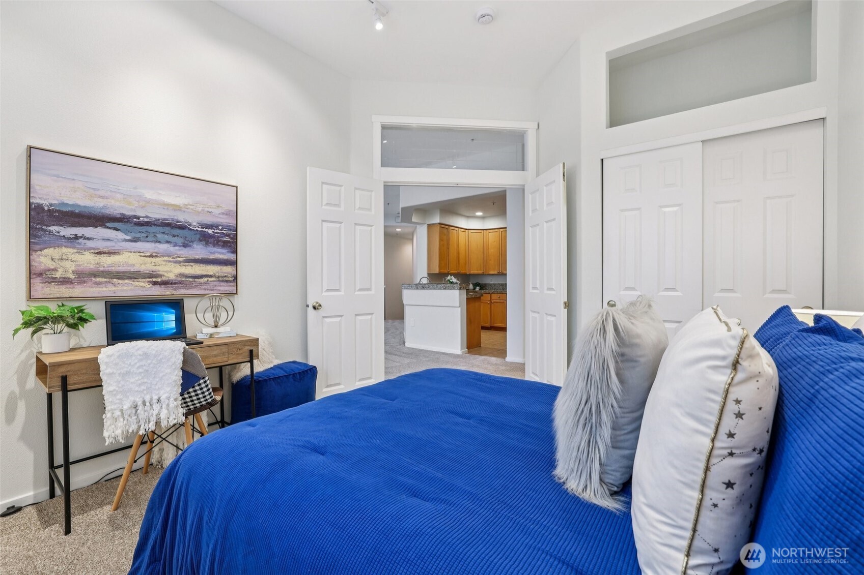 4322 Northeast 5th Court, Unit 105 Renton, WA 98059 - Photo 17 of 36 a bedroom with a bed and a chandelier