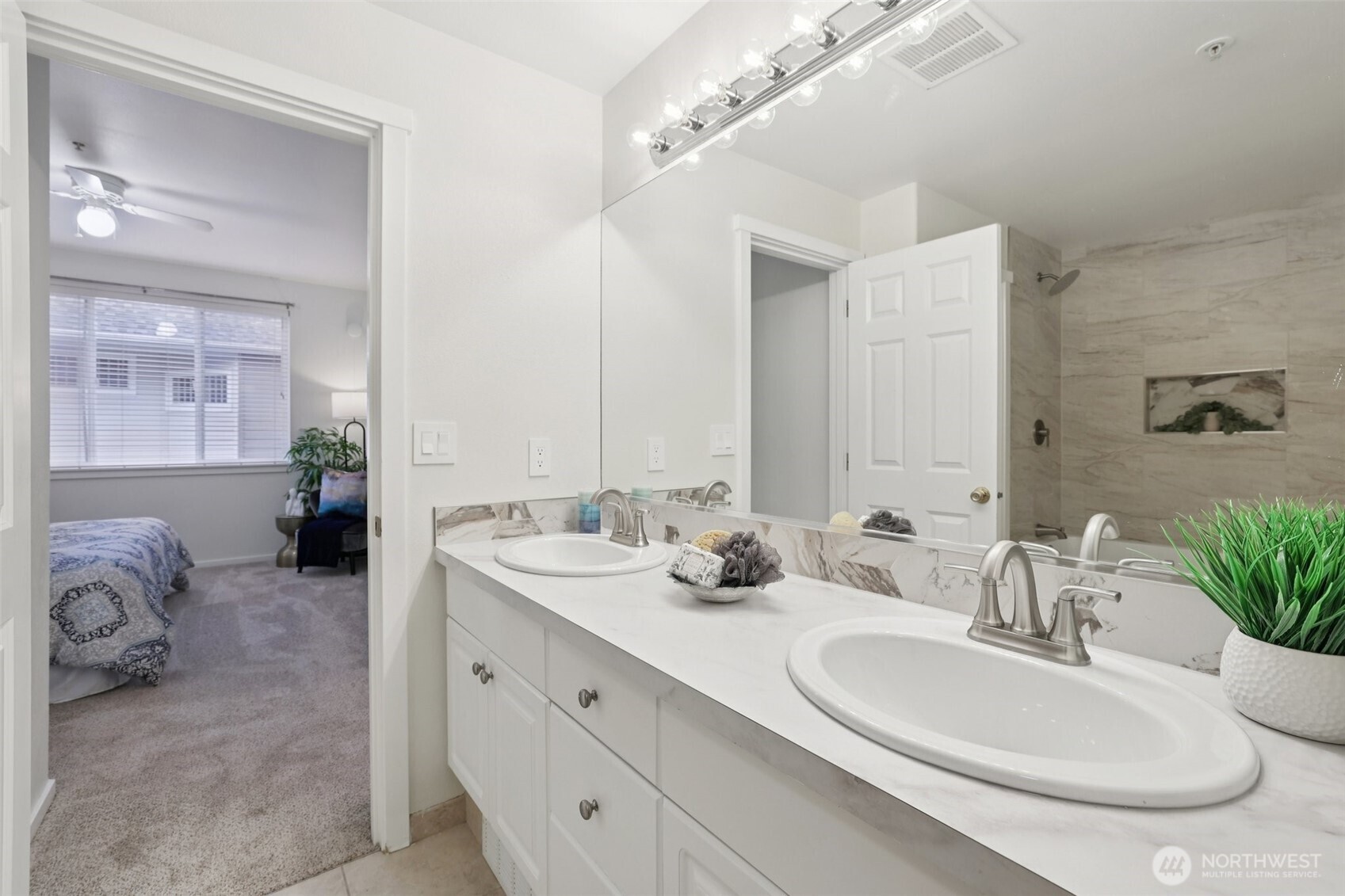 4322 Northeast 5th Court, Unit 105 Renton, WA 98059 - Photo 23 of 36 a en suite bathroom with double sink and a mirror