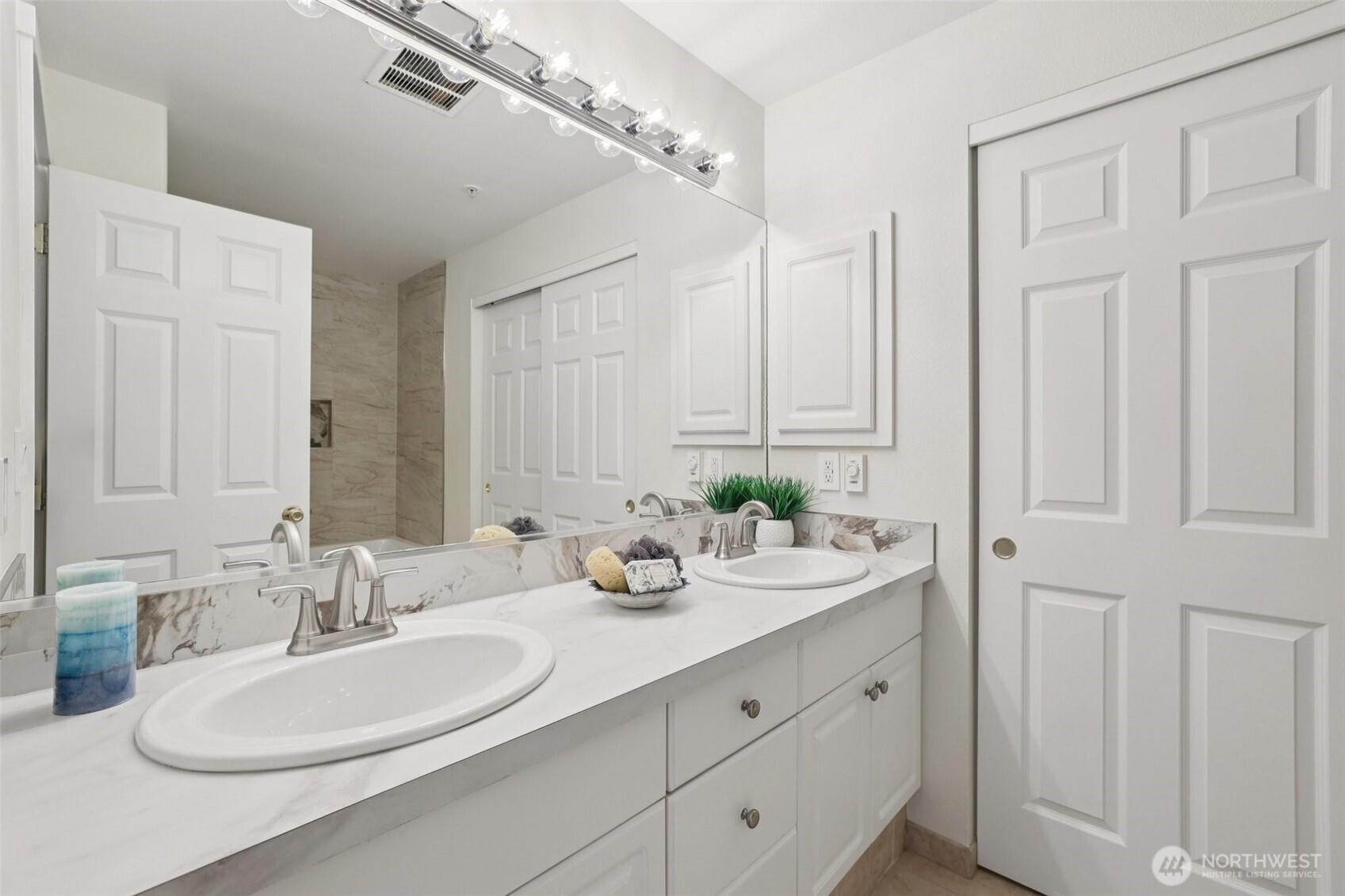 4322 Northeast 5th Court, Unit 105 Renton, WA 98059 - Photo 24 of 36 a bathroom with double vanity sinks and a mirror