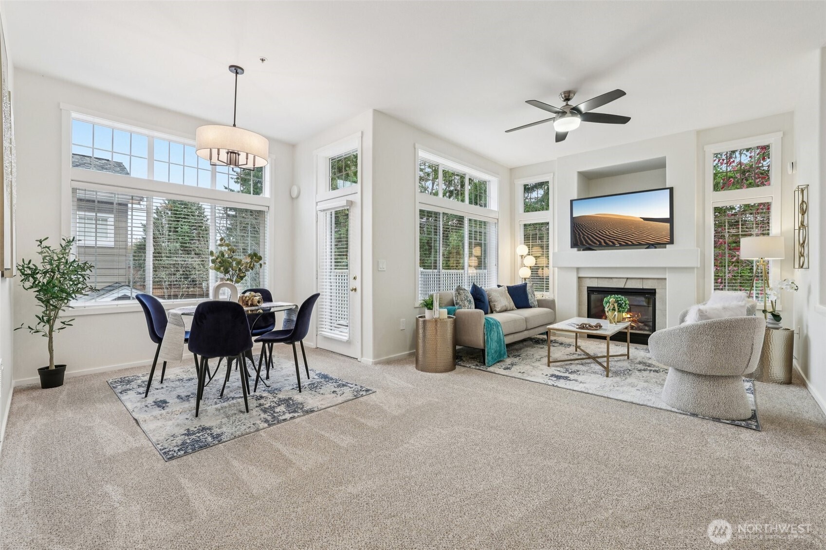 4322 Northeast 5th Court, Unit 105 Renton, WA 98059 - Photo 9 of 36 a living room with furniture a fireplace and a chandelier