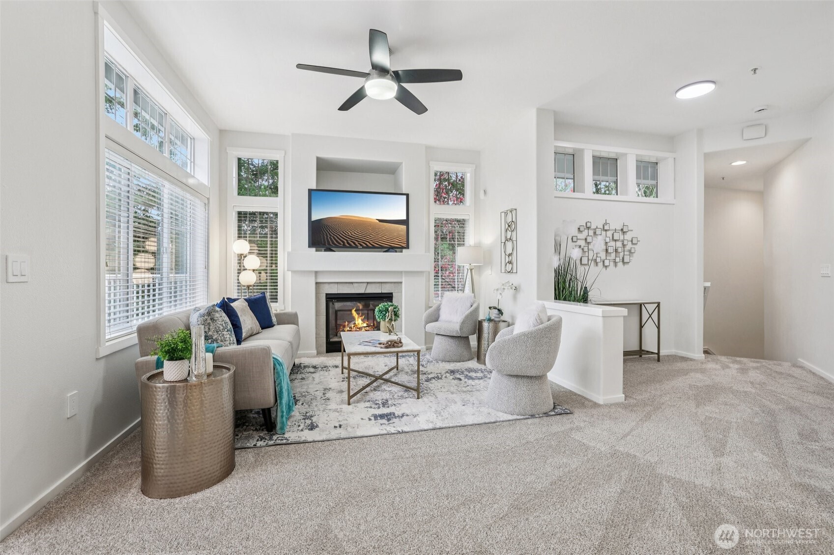 4322 Northeast 5th Court, Unit 105 Renton, WA 98059 - Photo 10 of 36 a living room with furniture a fireplace and a flat screen tv