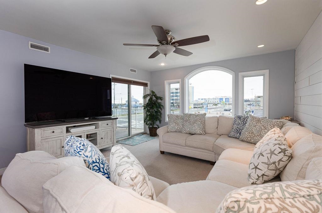 415 East Heather Road, Unit 106 Wildwood Crest, NJ 08260 - Photo 11 of 41 a living room with furniture and a flat screen tv