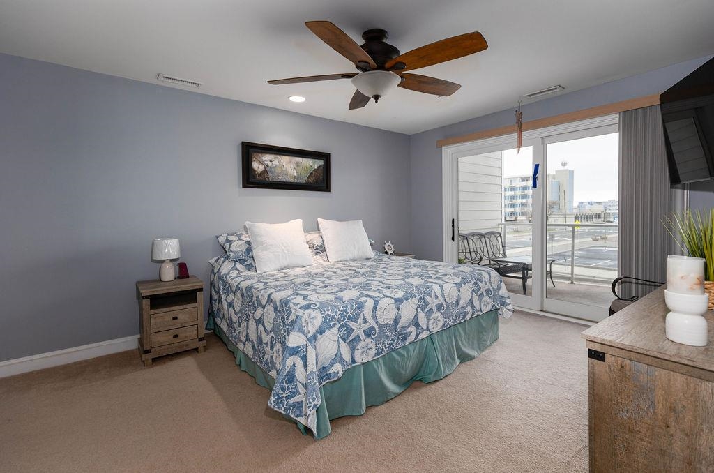 415 East Heather Road, Unit 106 Wildwood Crest, NJ 08260 - Photo 15 of 41 a bedroom with a bed and a large window