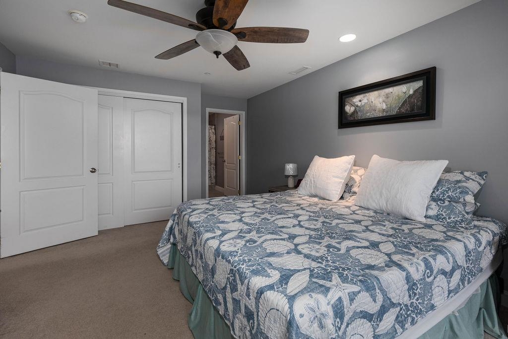 415 East Heather Road, Unit 106 Wildwood Crest, NJ 08260 - Photo 16 of 41 a bedroom with a bed and a painting on the wall