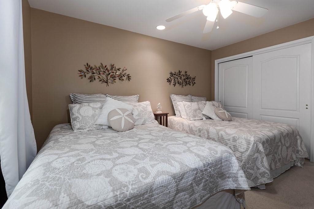 415 East Heather Road, Unit 106 Wildwood Crest, NJ 08260 - Photo 18 of 41 a large bed sitting in a bedroom and a chandelier