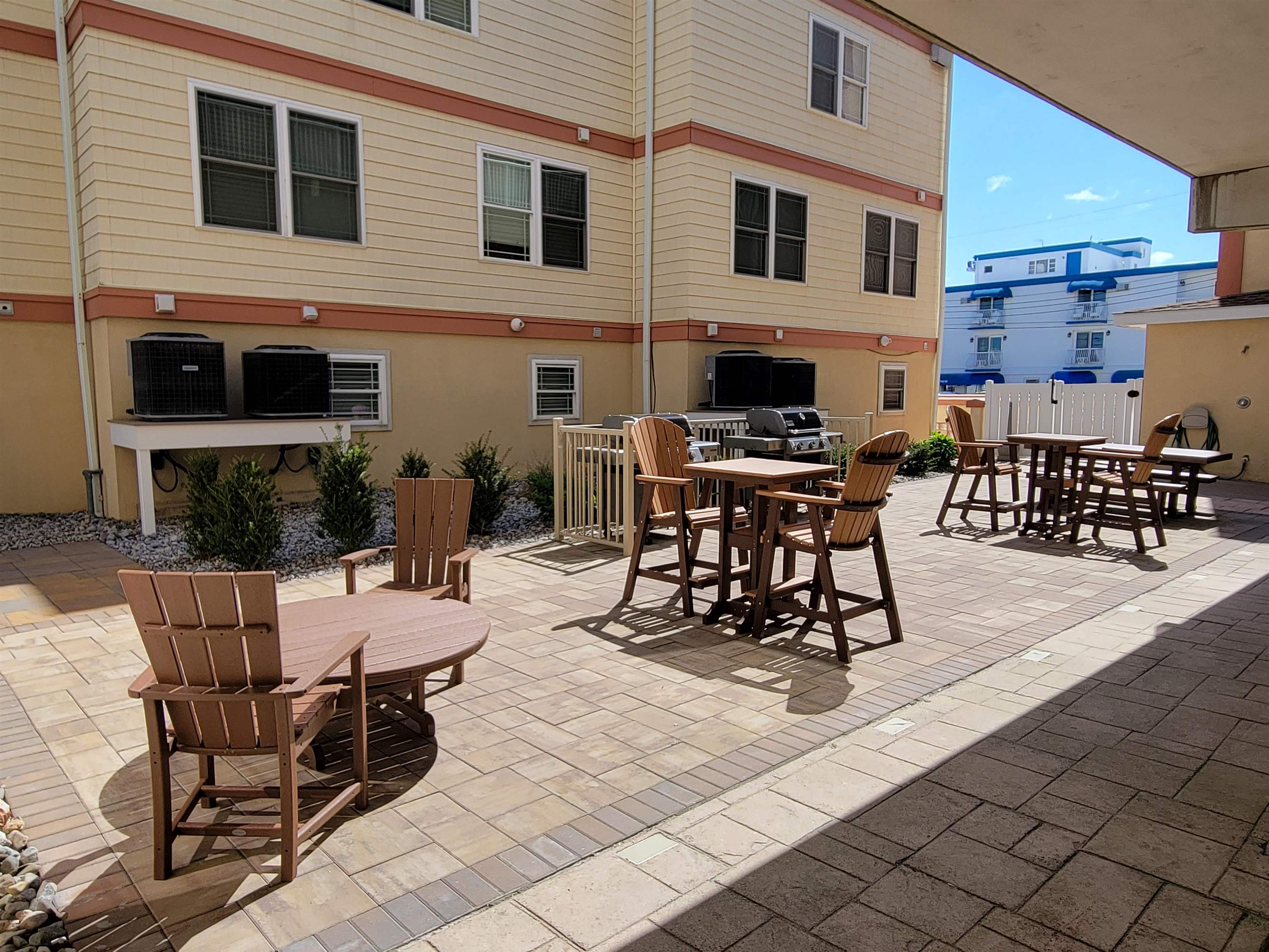 415 East Heather Road, Unit 106 Wildwood Crest, NJ 08260 - Photo 27 of 41 a building outdoor space with patio furniture