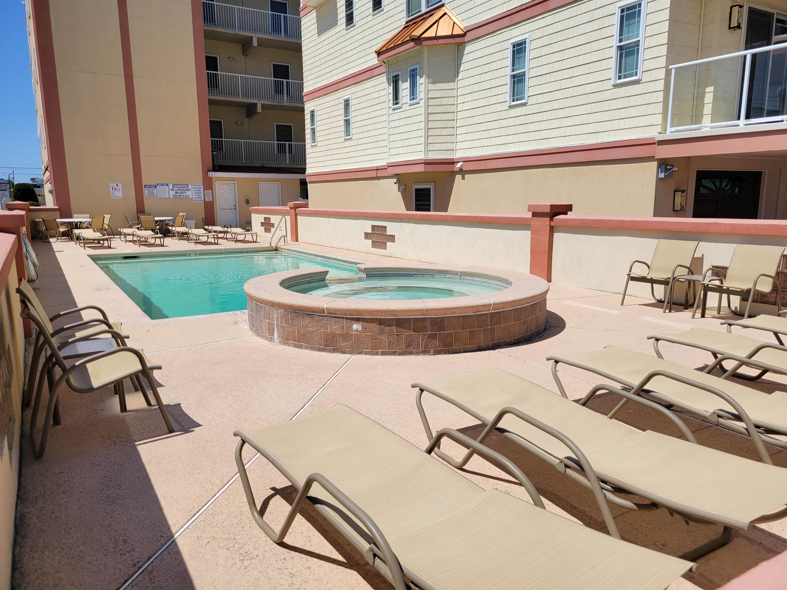 415 East Heather Road, Unit 106 Wildwood Crest, NJ 08260 - Photo 3 of 41 a swimming pool with outdoor seating and yard