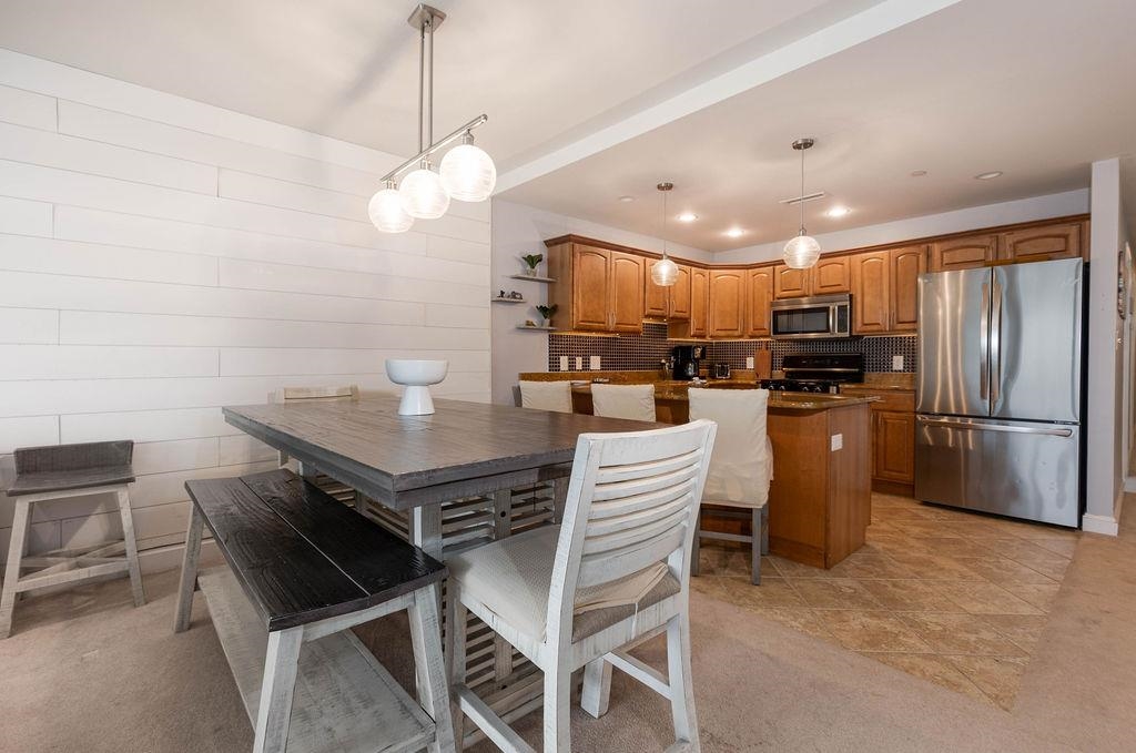 415 East Heather Road, Unit 106 Wildwood Crest, NJ 08260 - Photo 6 of 41 a kitchen with kitchen island a counter space a sink appliances and cabinets