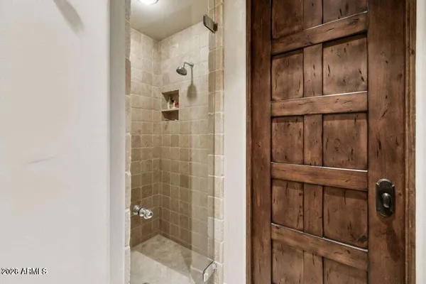 a bathroom with a glass shower door