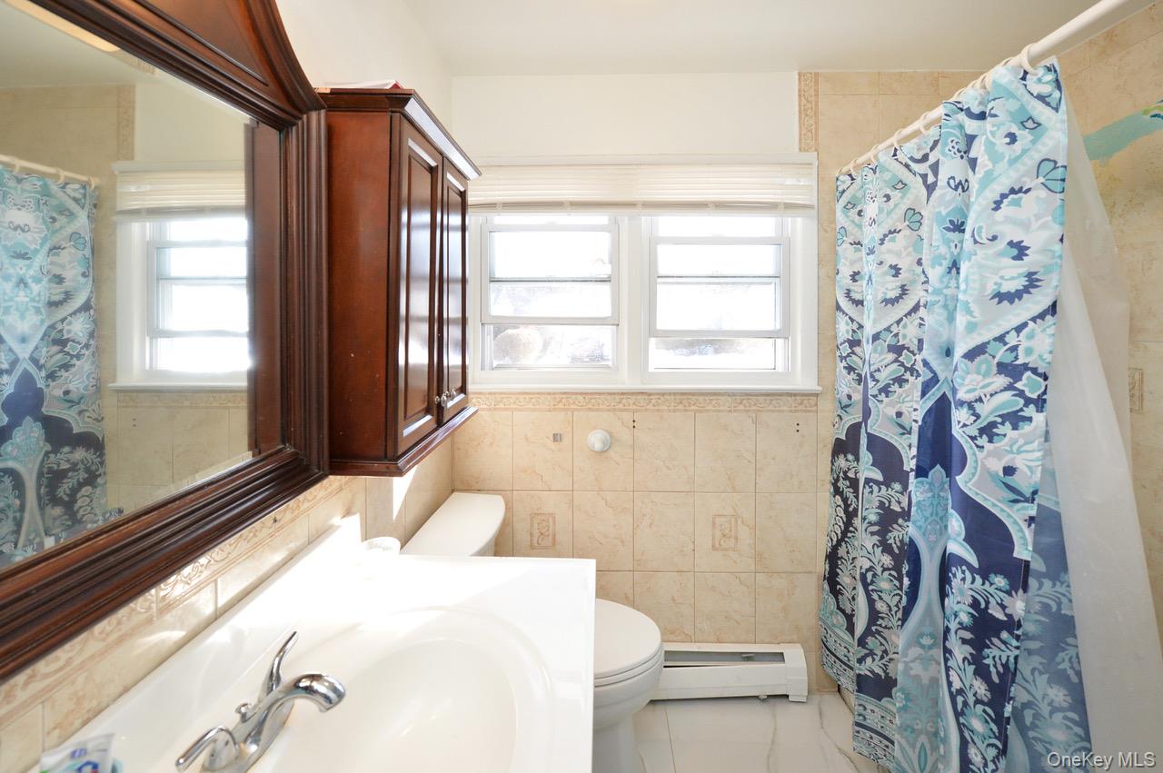 7 South Oak Street Spring Valley, NY 10977 - Photo 17 of 24 a bath room with a large window and a bath tub