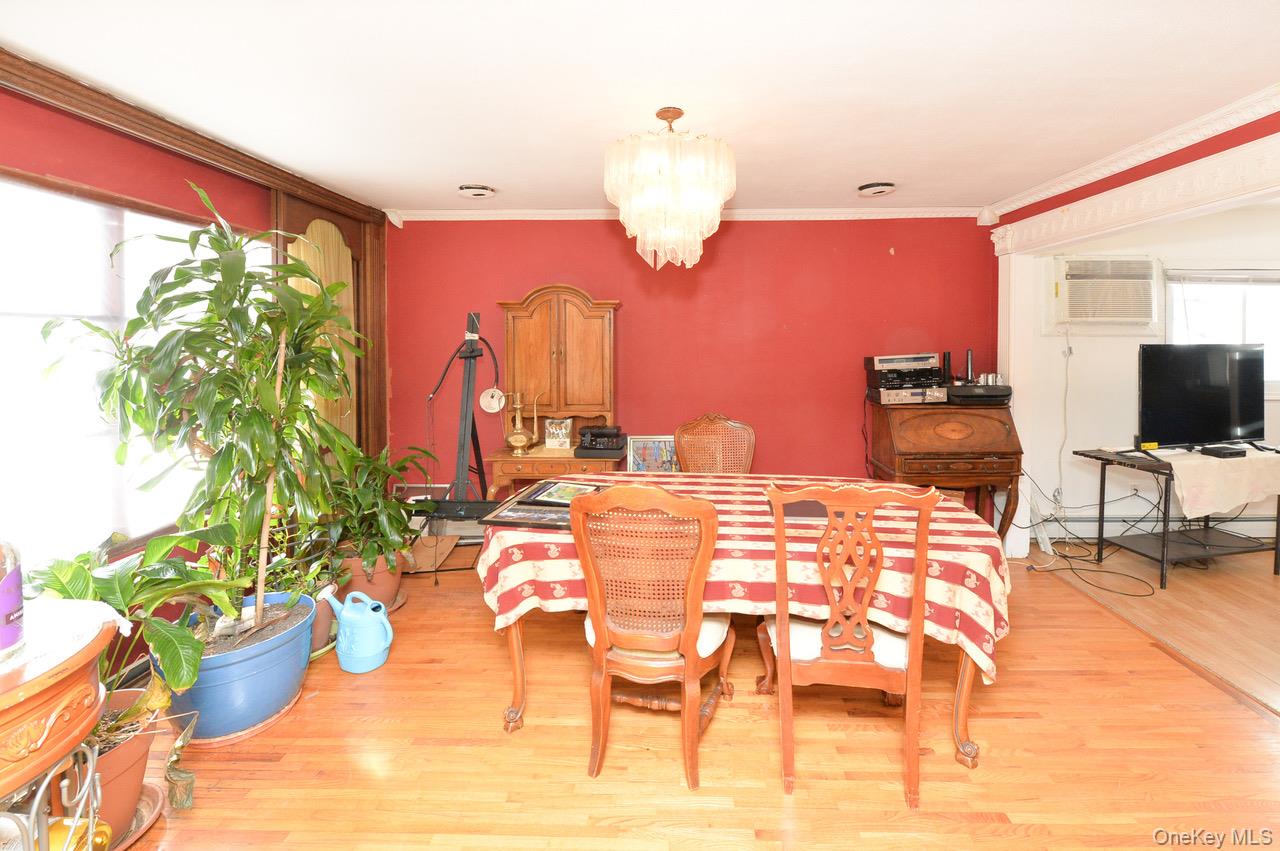 7 South Oak Street Spring Valley, NY 10977 - Photo 4 of 24 a dining room with furniture and a chandelier