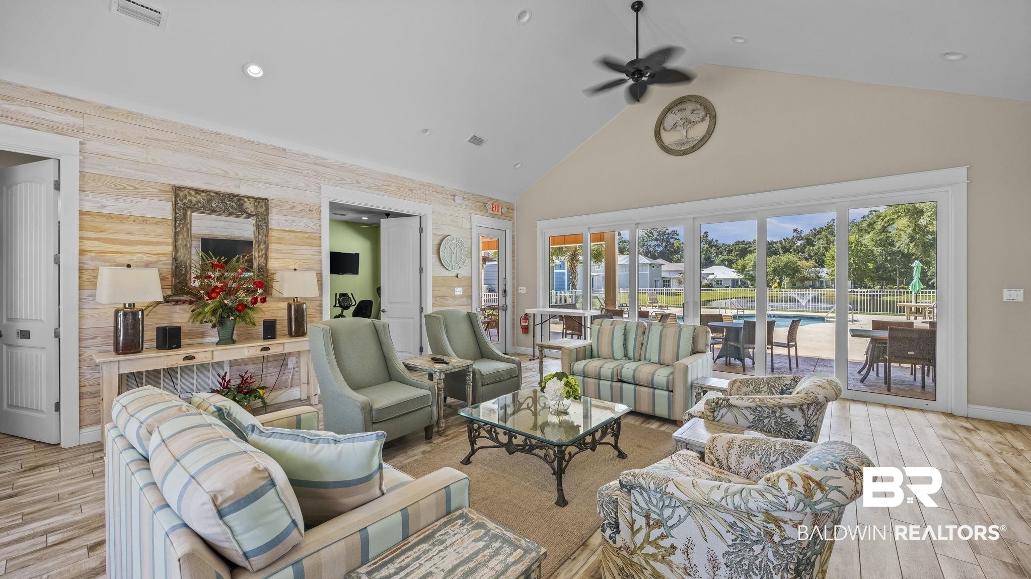 12361 Reunion Place Foley, AL 36535 - Photo 6 of 43 Living room featuring wood finish floors, wooden walls, high vaulted ceiling, an accent wall, and ceiling fan