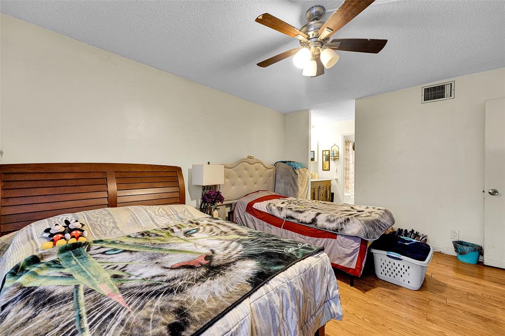 7041 Environ Boulevard, Unit 326 Lauderhill, FL 33319 - Photo 15 of 44 a bedroom with two bed and a chandelier
