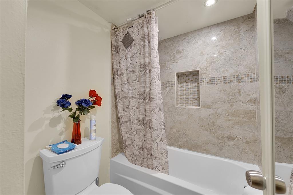 7041 Environ Boulevard, Unit 326 Lauderhill, FL 33319 - Photo 18 of 44 a bathroom with a shower a toilet and a sink