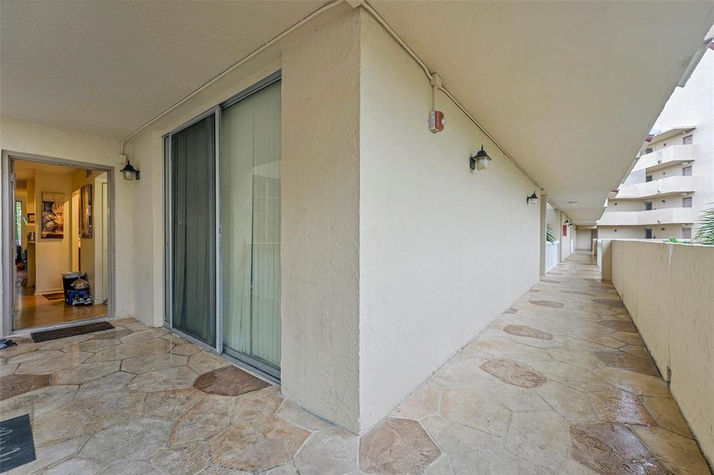 7041 Environ Boulevard, Unit 326 Lauderhill, FL 33319 - Photo 21 of 44 a view of a hallway with wooden floor and entryway