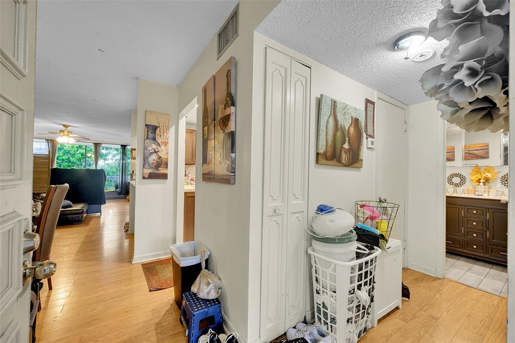 7041 Environ Boulevard, Unit 326 Lauderhill, FL 33319 - Photo 3 of 44 a hallway with a couch and chandelier