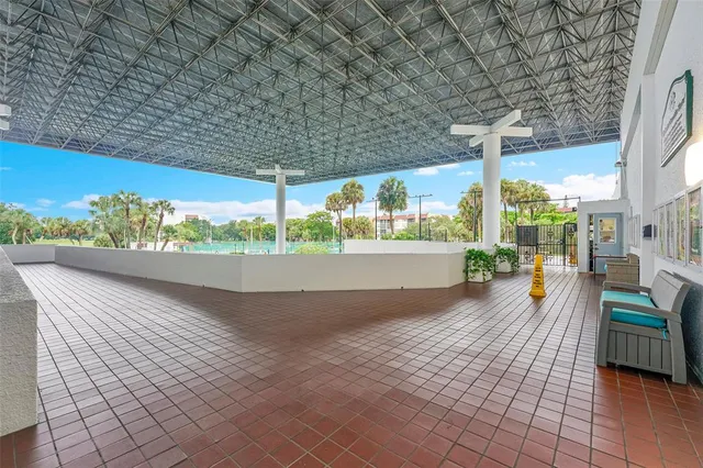 a view of a patio with a table and chairs potted plants