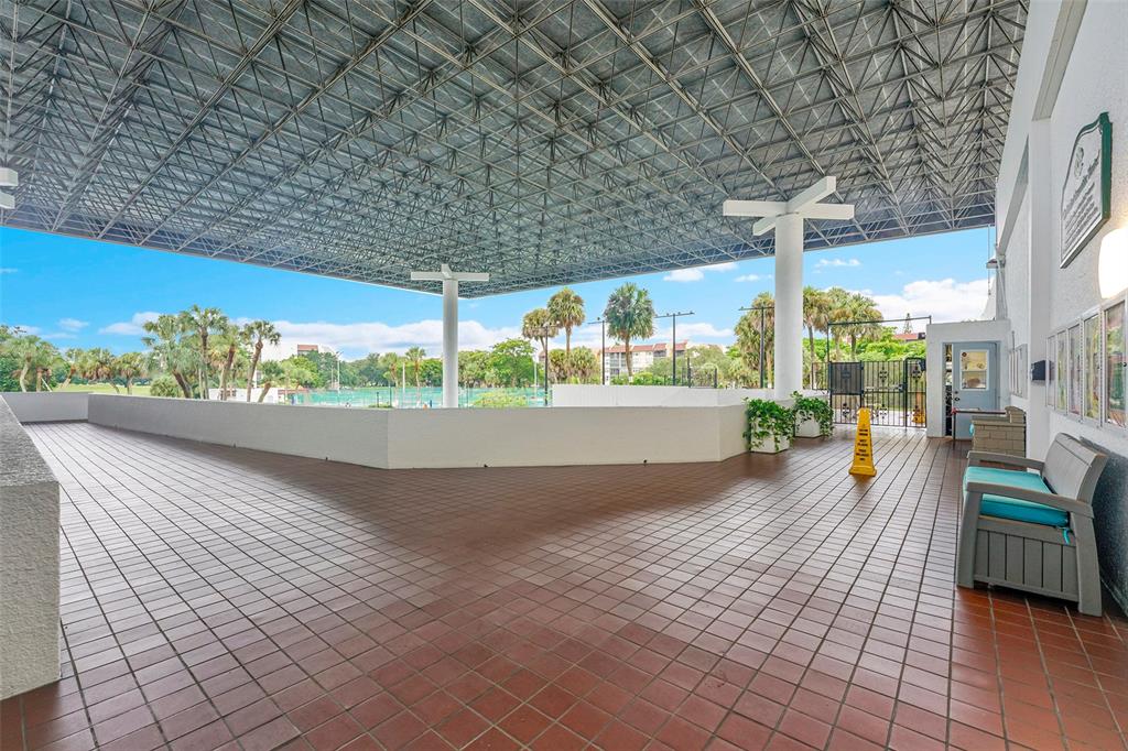 7041 Environ Boulevard, Unit 326 Lauderhill, FL 33319 - Photo 38 of 44 a view of a patio with a table and chairs potted plants